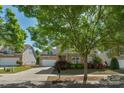 Inviting home with stone and siding exterior, landscaping, and a driveway leading to the garage at 3009 Scottcrest Way, Waxhaw, NC 28173