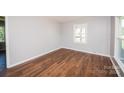 Cozy bedroom featuring hardwood floors, neutral walls, and bright, natural lighting at 3029 Wendover Nw Rd, Concord, NC 28027