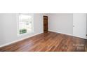 Bright bedroom featuring hardwood floors, neutral walls, and a window with natural light at 3029 Wendover Nw Rd, Concord, NC 28027