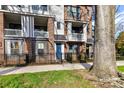 Brick townhome exterior with a small fenced yard and a pop of color from a bright blue front door at 3064 Selwyn Ave, Charlotte, NC 28209