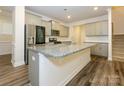 Modern kitchen with stainless steel appliances, granite countertops, and a spacious island at 4242 Plumeria Way, Fort Mill, SC 29707