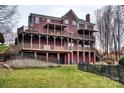 Backyard view of large two story home with multi-level decks and green grass at 649 46Th Avenue Ne Dr, Hickory, NC 28601