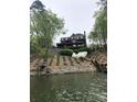 Exterior view from the lake of a brick two story home with multi-level decks at 649 46Th Avenue Ne Dr, Hickory, NC 28601