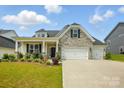 Charming home with stone accents, inviting curb appeal, and a two car garage at 6858 Hunts Mesa Dr, Fort Mill, SC 29707