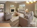 Bright living room featuring neutral walls, modern fireplace, and stylish furniture arrangement at 8069 Cedar Glen Dr, Charlotte, NC 28212