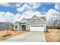 Traditional home with a two-car garage, gray siding and stone accents with long driveway at 8716 Acadia Pkwy # 596, Sherrills Ford, NC 28673