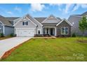 Single-Gathering home with gray siding, a well-manicured lawn, stone accents and an attached two-car garage at 8716 Acadia Pkwy # 596, Sherrills Ford, NC 28673