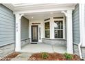 Inviting front entrance featuring decorative glass door, sidelights, and stylish stone accents at 8716 Acadia Pkwy # 596, Sherrills Ford, NC 28673