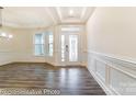Spacious room featuring tray ceiling, decorative molding, beautiful hardwood floors, and abundant natural light at 8716 Acadia Pkwy # 596, Sherrills Ford, NC 28673
