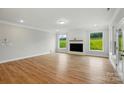 Bright living room featuring a fireplace, windows with a green view, and wood-look floors at 8716 Acadia Pkwy # 596, Sherrills Ford, NC 28673