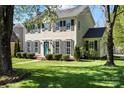 Classic two-story home with manicured lawn, symmetrical design, and a vibrant blue front door at 9108 Clifton Meadow Dr, Matthews, NC 28105