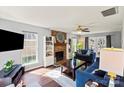 Inviting living room featuring a brick fireplace, ample natural light, and cozy, stylish furnishings at 9108 Clifton Meadow Dr, Matthews, NC 28105