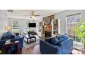 Cozy living room with a brick fireplace, built-in bookshelves, and comfortable seating area at 9108 Clifton Meadow Dr, Matthews, NC 28105