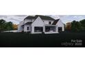Expansive backyard featuring a brick-clad two-story home with a covered patio, and lush landscaping at 1017 Broadmoor Dr # 60, Marvin, NC 28173