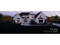 Beautiful two-story home with a brick exterior, black trim windows, manicured lawn, and professional landscaping at 1017 Broadmoor Dr # 60, Marvin, NC 28173