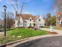 Charming two-story home with a well-manicured lawn, attached garage, and inviting curb appeal at 10700 Summitt Tree Ct, Charlotte, NC 28277
