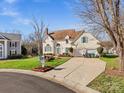 Inviting two-story home with an attached garage, complemented by lush green grass at 10700 Summitt Tree Ct, Charlotte, NC 28277