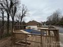 Exterior shot showcasing a community pool area, featuring a wooden deck and partially covered pool at 1420 11Th Street Nw Dr # 25, Hickory, NC 28601