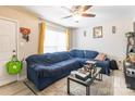 Living room featuring a cozy blue sectional sofa with natural light at 1465 Flintwood Dr, Rock Hill, SC 29732