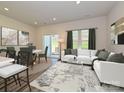 Inviting living room and dining area featuring a white couch, windows and sliding glass doors to the outside at 1758 Braemar Village Dr, Monroe, NC 28110