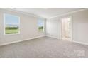 Bright bedroom with two windows and plush carpet, offering a cozy and comfortable space at 1762 Braemar Village Dr, Monroe, NC 28110