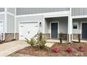Inviting townhome with a one-car garage, brick accents, and a cozy front entrance at 1762 Braemar Village Dr, Monroe, NC 28110