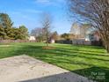 Expansive, well-maintained backyard with a wooden fence and a concrete patio at 2020 Holly Villa Cir, Indian Trail, NC 28079