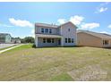 Spacious backyard with ample lawn space, covered patio, and neighboring house at 2204 Camber Dr # Cwo0076, Gastonia, NC 28054