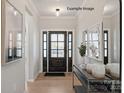Inviting foyer with hardwood floors, paneled front door, and decorative console table with art and mirror accents at 2204 Camber Dr # Cwo0076, Gastonia, NC 28054