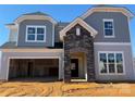 New two-story home featuring stone accents, a covered entryway, a two-car garage, and gray shingle and siding at 2204 Camber Dr # Cwo0076, Gastonia, NC 28054