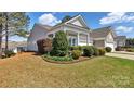 Charming home showcasing a lush lawn, mature landscaping and well-maintained exterior at 3008 Sweetleaf Dr, Fort Mill, SC 29707