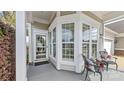 Inviting covered porch features a seating area, neutral paint and large windows at 3008 Sweetleaf Dr, Fort Mill, SC 29707