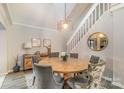 Elegant dining room with round wooden table, gray upholstered chairs, and stylish decor, creating a cozy space at 317 Commodore Loop, Mooresville, NC 28117