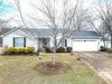 Well-maintained single-Gathering home with mature trees, a two-car garage, and a neatly landscaped front yard at 3248 St Vincent Dr, Claremont, NC 28610
