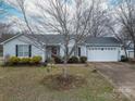Well-maintained single-Gathering home with mature trees, a two-car garage, and a neatly landscaped front yard at 3248 St Vincent Dr, Claremont, NC 28610