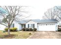 A beautiful house showing great curb appeal, with mature trees, a green lawn, and an attached two-car garage at 3248 St Vincent Dr, Claremont, NC 28610