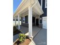 Inviting covered front porch with stone accents, providing a cozy and stylish entry to the home at 334 Knotty Wood Dr # 68, Monroe, NC 28110