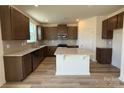 Open kitchen featuring an island, stainless steel appliances, and granite countertops at 334 Knotty Wood Dr # 68, Monroe, NC 28110