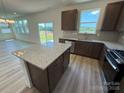 Open kitchen featuring an island, stainless steel appliances, and granite countertops at 334 Knotty Wood Dr # 68, Monroe, NC 28110