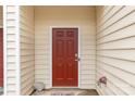A close up of the red front door, siding and a 'Dogs Welcome' door mat at 446 Clouds Way Way, Rock Hill, SC 29732