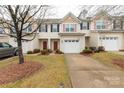 Charming townhome with a one car garage, red front door, and freshly landscaped front yard at 446 Clouds Way Way, Rock Hill, SC 29732