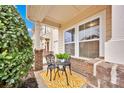 Charming front porch featuring decorative bistro table, chairs, and bright yellow rug at 4708 Tradd Cir, Monroe, NC 28110