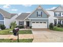 Attractive home with a manicured lawn, complemented by beautiful landscaping at 50143 Robins Nest Ln, Lancaster, SC 29720