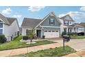 Charming home featuring manicured lawn, attractive landscaping, and a two-car garage at 50143 Robins Nest Ln, Lancaster, SC 29720