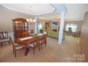 Open-concept dining and living area with elegant furnishings and a fireplace, ideal for entertaining at 514 Galesburg Dr, Monroe, NC 28110