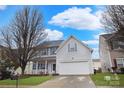 Inviting two-story home with a two-car garage, featuring blue shutters and a neatly landscaped front yard at 514 Galesburg Dr, Monroe, NC 28110