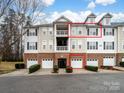 Townhome with brick facade, private balcony, dormer windows, and attached garage at 6792 Mallard Park Dr, Charlotte, NC 28262
