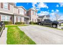 Street view of townhome with green lawn, driveway, and space for two parked cars at 8263 Carob Tree Ln, Charlotte, NC 28215