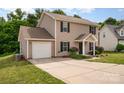 Beautiful home with a two-car garage, mature landscaping, and a welcoming front entrance at 8309 Knapp Ct, Locust, NC 28097