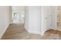 Hallway with durable floors leading to a bathroom and living space with natural light at 10113 Mamillion Dr, Huntersville, NC 28078